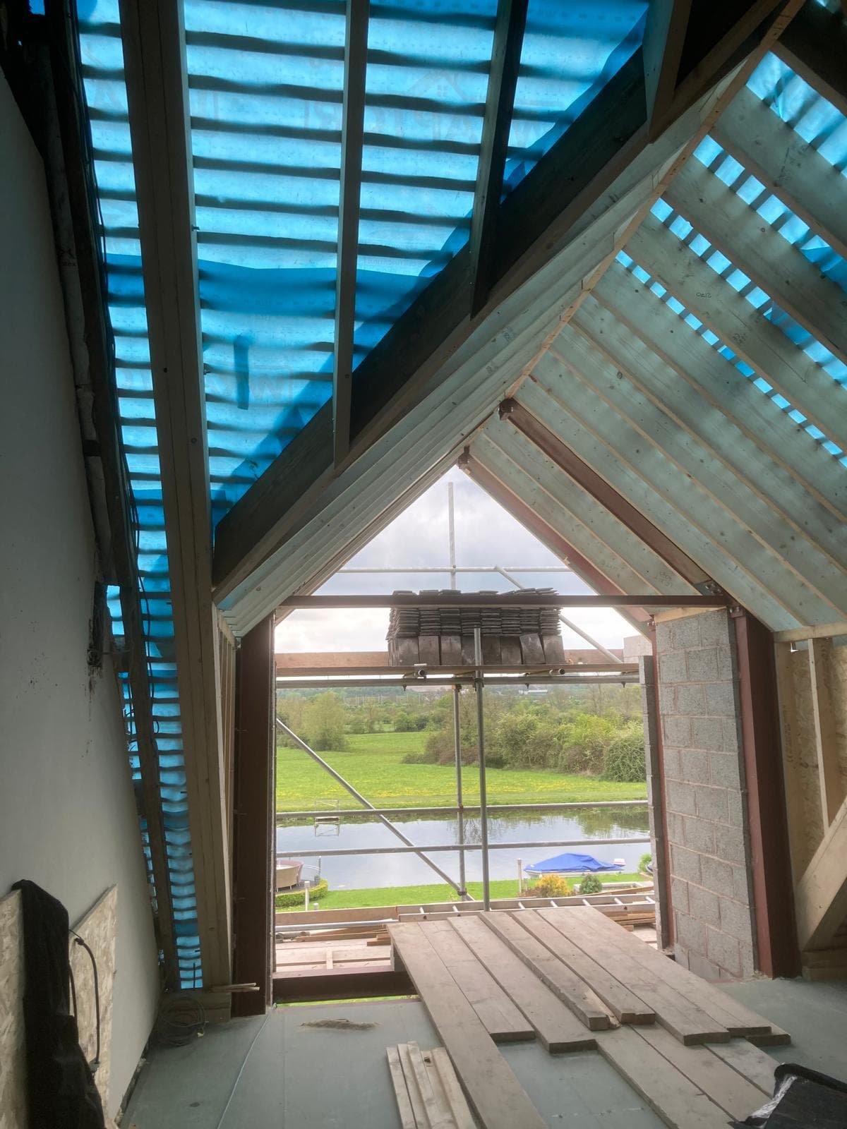 Vaulted ceiling with rooflights above a fully glazed gable end.