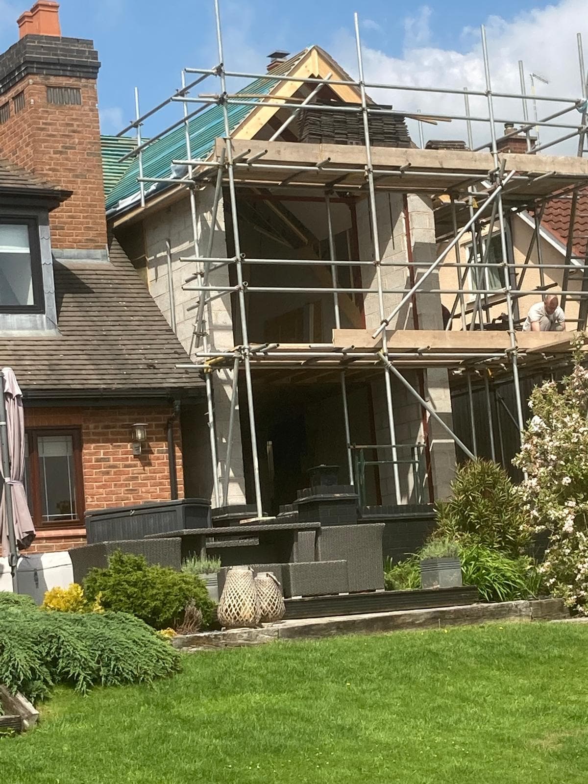 Rear of a house under scaffolding during refurbishment works.