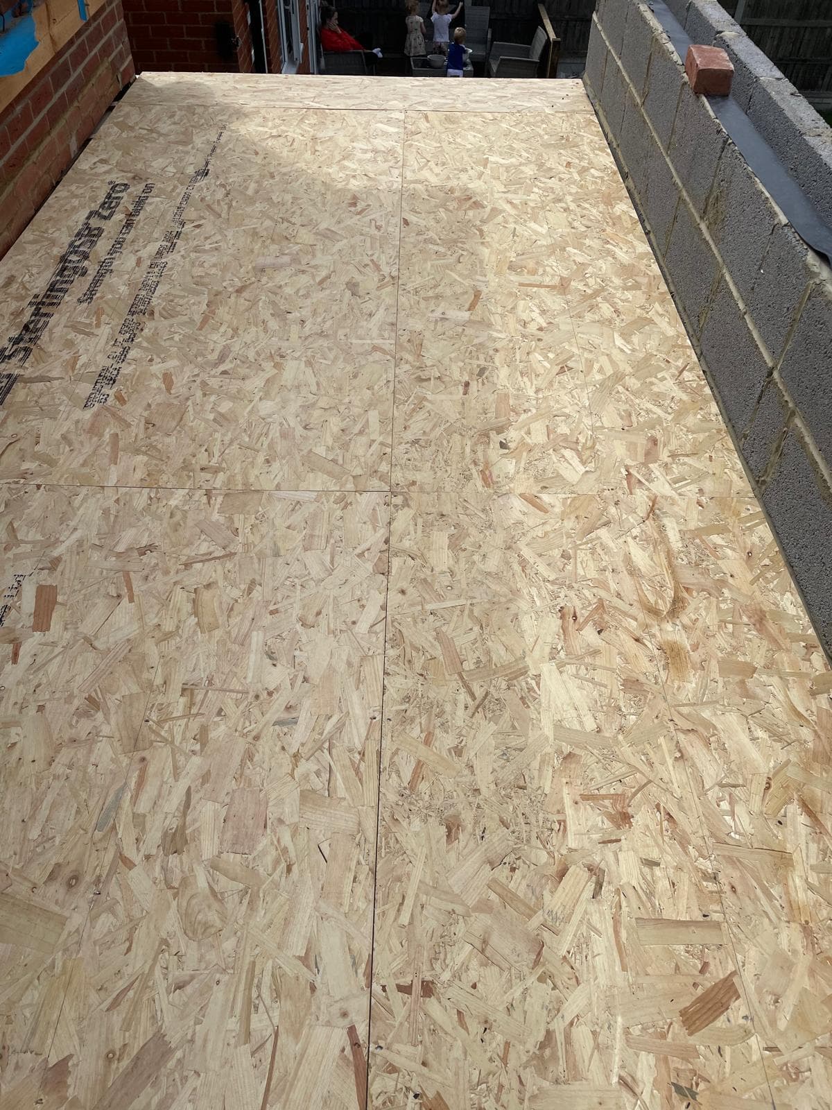 New OSB floor deck laid across joists at first-floor level.