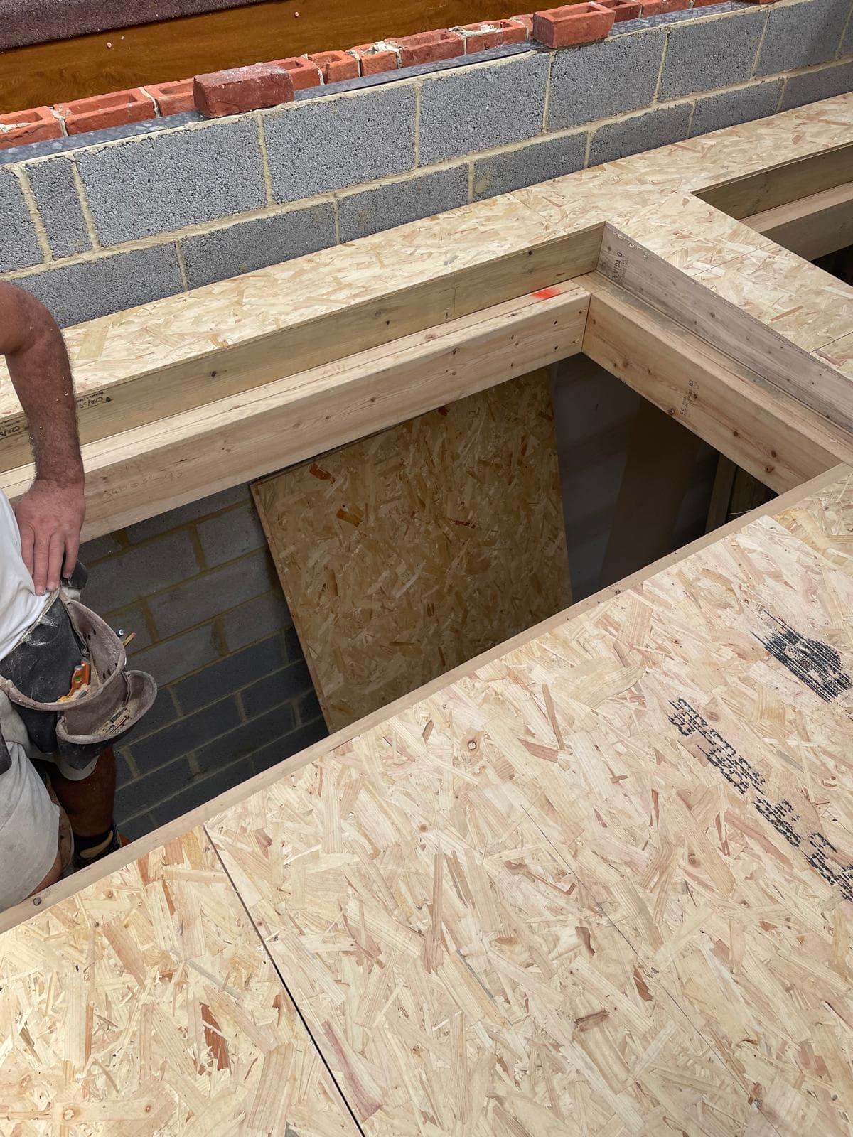 Stairwell opening formed in a new timber and OSB floor deck.