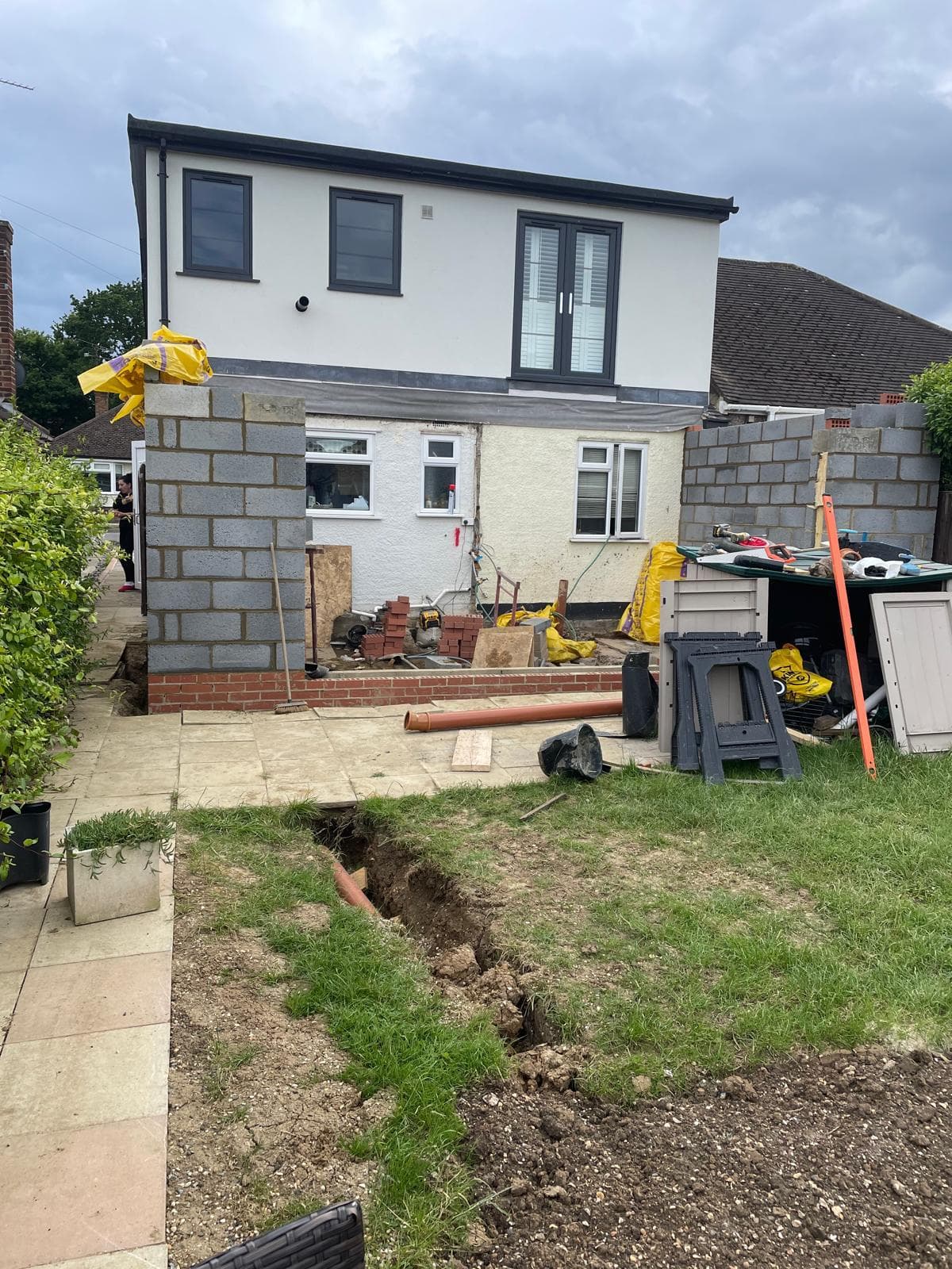 Rear of a rendered property with new blockwork extension walls going up.