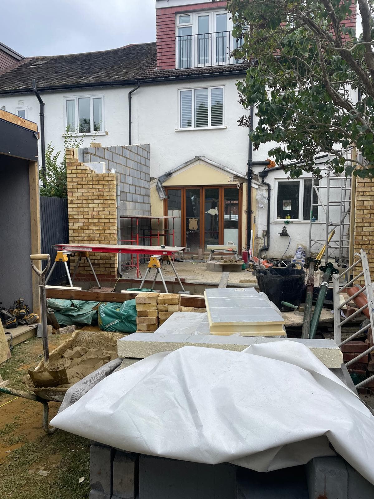Rear extension with reclaimed brick piers, new steelwork and bifold doors.