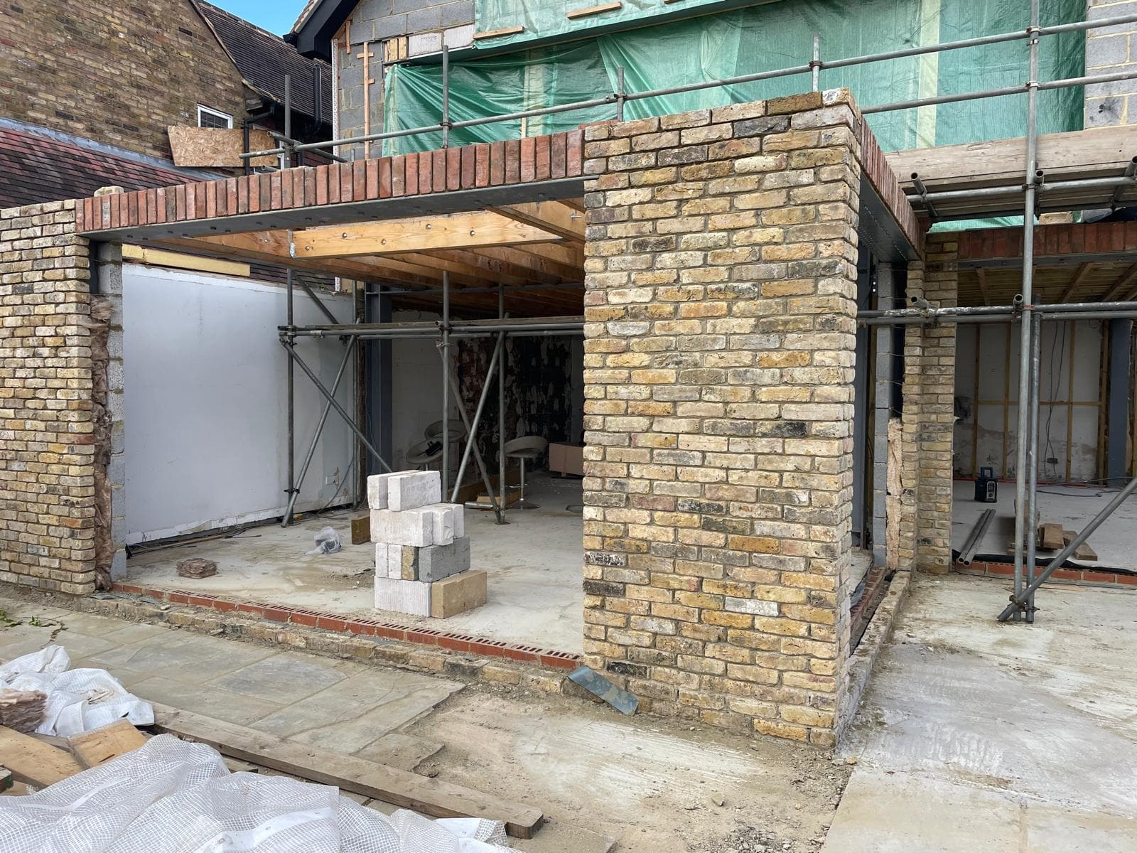 New brick extension under scaffolding during construction.